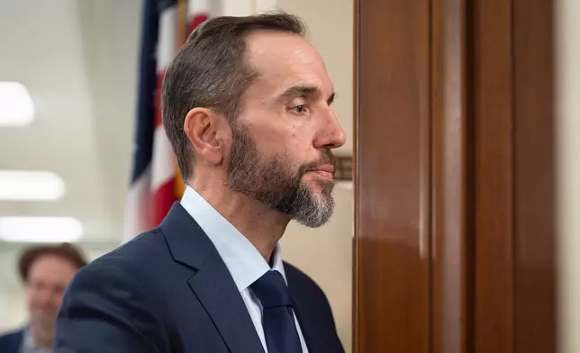 Former Department of Justice Special Counsel Jack Smith enters a room in the Rayburn House Office Building to give his deposition before the House Judiciary Committee, part of its oversight into DOJ investigations into President Donald Trump, on Capitol Hill in Washington, Wednesday, Dec. 17, 2025. (AP Photo/J. Scott Applewhite)