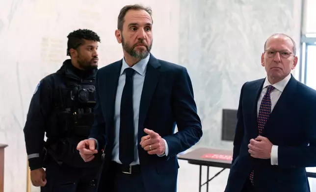 Former Department of Justice Special Counsel Jack Smith, center, and his attorney Lanny Breuer arrive for a closed-door interview with House Republicans at Capitol Hill, Wednesday, Dec. 17, 2025, in Washington. (AP Photo/Jose Luis Magana)