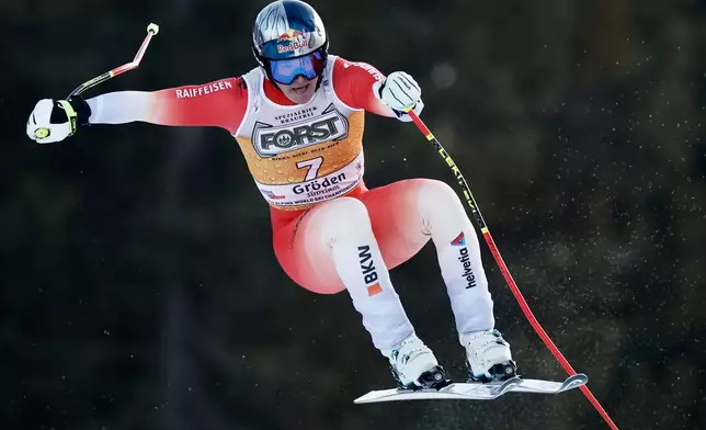 Switzerland's Franjo von Allmen speeds down the course during an alpine ski, men's World Cup downhill, in Val Gardena, Italy, Saturday, Dec. 20, 2025. (AP Photo/Gabriele Facciotti)