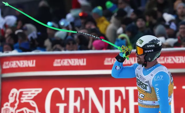 Italy's Florian Schieder celebrates at the finish area of an alpine ski, men's World Cup downhill, in Val Gardena, Italy, Saturday, Dec. 20, 2025. (AP Photo/Alessandro Trovati)