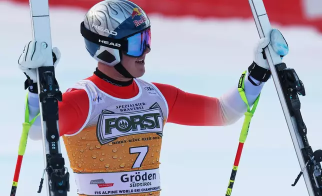 Switzerland's Franjo von Allmen celebrates at the finish area of an alpine ski, men's World Cup downhill, in Val Gardena, Italy, Saturday, Dec. 20, 2025. (AP Photo/Alessandro Trovati)