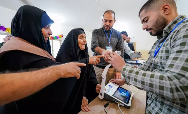 FILE - Voters gather to cast their vote at a ballot station in the country's parliamentary election in Najaf, Iraq, Nov. 11, 2025. (AP Photo/Anmar Khalil, File)