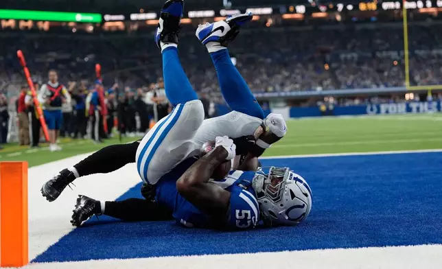 Indianapolis Colts linebacker Germaine Pratt (53) intercepts a pass intended for Jacksonville Jaguars wide receiver Parker Washington during the first half of an NFL football game Sunday, Dec. 28, 2025, in Indianapolis. (AP Photo/Carolyn Kaster)