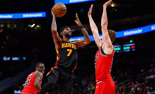 Atlanta Hawks guard Nickeil Alexander-Walker (7) looks to shoot over Chicago Bulls guard Kevin Huerter, right, during the second half of an NBA basketball game, Sunday, Dec. 21, 2025, in Atlanta. (AP Photo/Colin Hubbard)