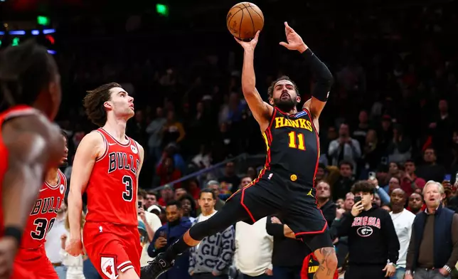 Atlanta Hawks guard Trae Young (11) misses a game-tying shot as time expires against Chicago Bulls guard Josh Giddey (3) during the second half of an NBA basketball game, Sunday, Dec. 21, 2025, in Atlanta. (AP Photo/Colin Hubbard)