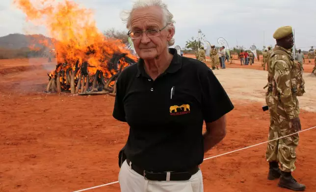 FILE - Iain Douglas-Hamilton, founder of Save the Elephants, poses in front of confiscated ivory at Kenya Wildlife Training School, Manyani, Kenya, Wednesday, July 20, 2011. (AP Photo/Sayyid Azim)