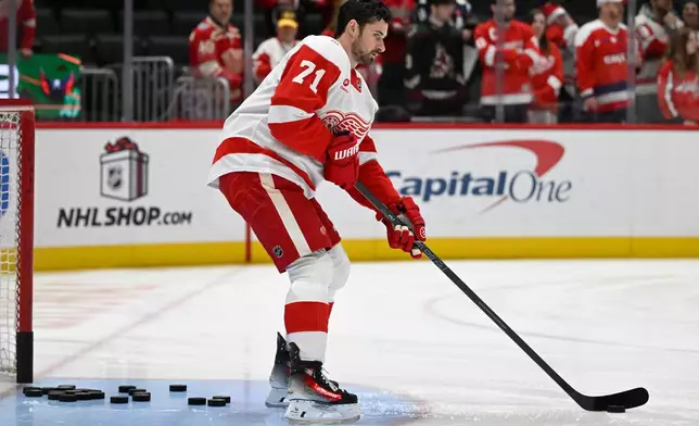 Detroit Red Wings center Dylan Larkin warms up before an NHL hockey game against the Washington Capitals Saturday, Dec. 20, 2025, in Washington. (AP Photo/John McDonnell)