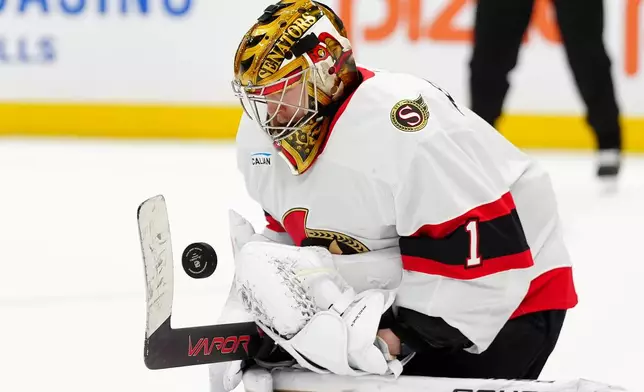 Ottawa Senators goaltender Leevi Meriläinen (1) makes a save during the second period of an NHL hockey game against the Toronto Maple Leafs in Toronto, Saturday, Dec. 27, 2025. (Frank Gunn/The Canadian Press via AP)