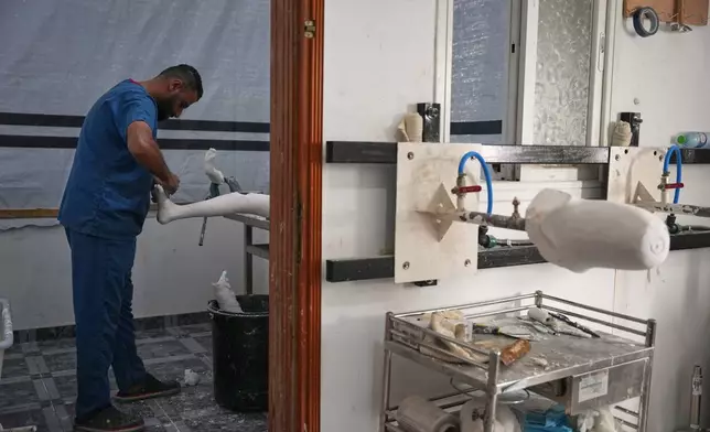 Prosthetic limb technician Ahmed Al-Ashqar, 34, prepares a leg amputation splint in the first stage of building an artificial leg at Hamad Hospital in Zawaida, central Gaza Strip, Thursday, Nov. 27, 2025. (AP Photo/Abdel Kareem Hana)