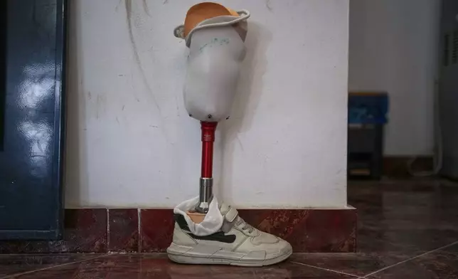 A prosthetic leg made for Fadi al-Balbisi, 12, whose right leg was amputated after a shell fired by the Israeli army on April 28, sits before a training session at Hamad Hospital in Zawaida, central Gaza Strip, Thursday, Dec. 4, 2025. (AP Photo/Abdel Kareem Hana)