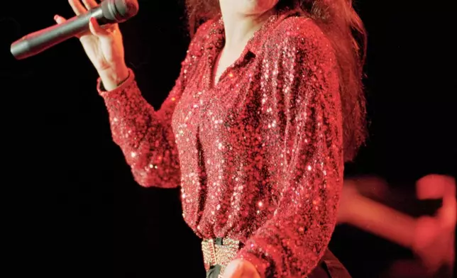 FILE - Selena performs on stage at Six Flags AstroWorld's Southern Star Amphitheater on July 31, 1994. (Howard Castleberry/Houston Chronicle via AP, File)