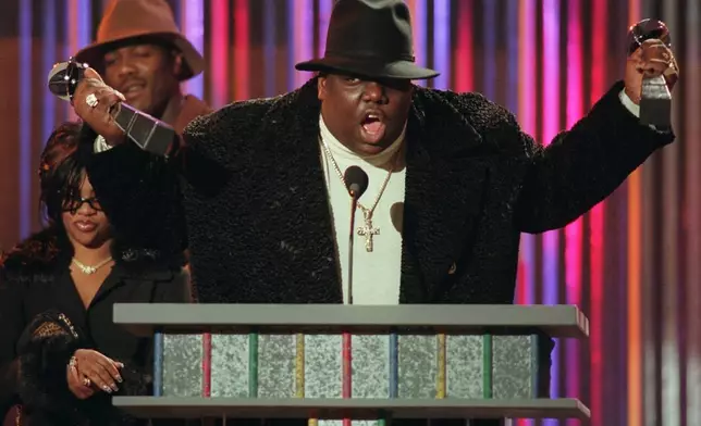 FILE - In this Dec. 6, 1995, file photo, The Notorious B.I.G., who won rap artist and rap single of the year, clutches his awards at the podium during the annual Billboard Music Awards in New York. (AP Photo/Mark Lennihan, File)