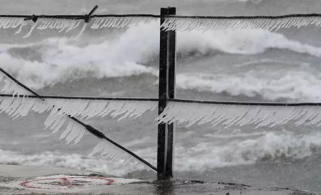 Icicles form along a pier at Loyola Beach, Saturday, Nov. 29, 2025, in Chicago. (AP Photo/Kiichiro Sato)