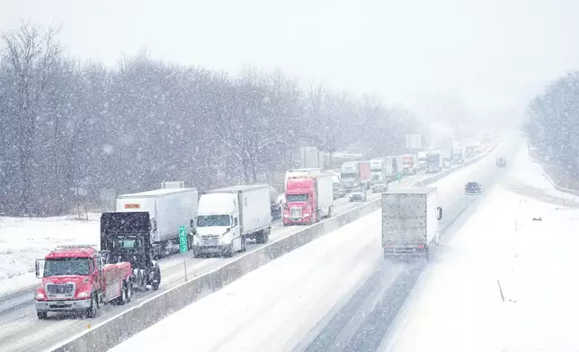 Vehicles slowly move during a storm on Interstate 78 in Kutztown, Pa., Tuesday, Dec. 2, 2025. (AP Photo/Matt Rourke)