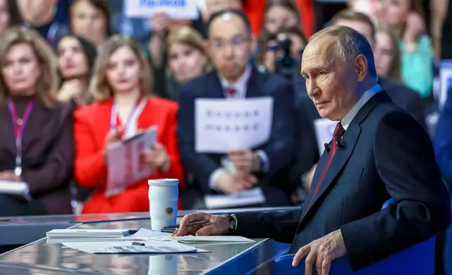 Russian President Vladimir Putin listens to a journalist's question during his annual news conference and call-in show at Gostinny Dvor, in Moscow, on Friday, Dec. 19, 2025. (Alexander Kazakov, Sputnik, Kremlin Pool Photo via AP)