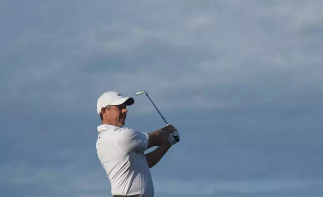 Rory McIlroy of Northern Ireland plays an approach shot on the 10th hole during the first round of the Australian Open golf tournament in Melbourne, Australia, Thursday, Dec. 4, 2025. (AP Photo/Asanka Brendon Ratnayake)