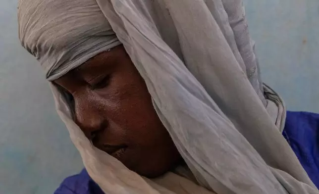FILE - Bakary Bah, who fled Mali in 2023 when more than a dozen people including his brother where killed in his village, sits for a portrait in a camp in Mbera, Mauritania, Tuesday, Nov. 4, 2025. (AP Photo/Caitlin Kelly, File)