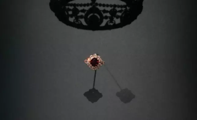 FILE - The tiara of Winifred Dallas-Yorke, Duchess of Portland and the jewelry set, crafted by Garrard, London, 1889, sapphires, diamonds and pearls set in gold and silver, created for Winifred Dallas-Yorke, Duchess of Portland are displayed at the exhibition "Dynastic Jewels" organized by The Al Thani Collection Foundation at the Hôtel de la Marine museum in Paris, France, Monday, Dec. 8, 2025. (AP Photo/Michel Euler, File)