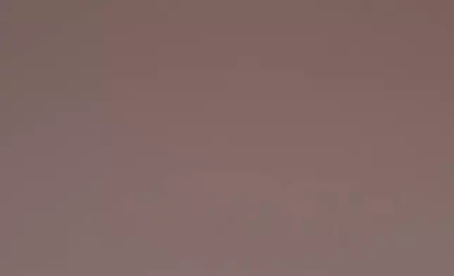 FILE - A Kashmiri man fishes from a traditional boat as the sun rises over Dal Lake on a foggy, cold morning in Srinagar, Indian controlled Kashmir, Wednesday, Dec. 3, 2025. (AP Photo/Dar Yasin, File)