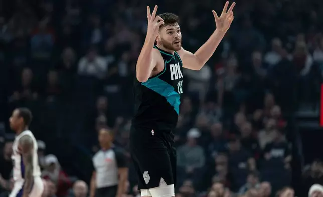 Portland Trail Blazers center Donovan Clingan, reacts after the made shot against the Sacramento Kings during the first half of an NBA basketball game, Thursday, Dec. 18, 2025, in Portland, Ore. (AP Photo/Howard Lao)