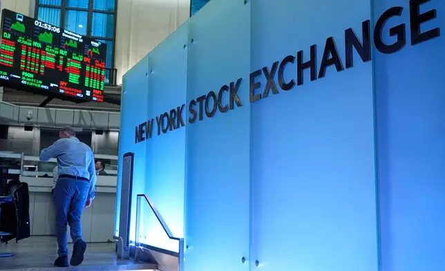 Traders work on the floor at the New York Stock Exchange in New York, Wednesday, Dec. 10, 2025. (AP Photo/Seth Wenig)