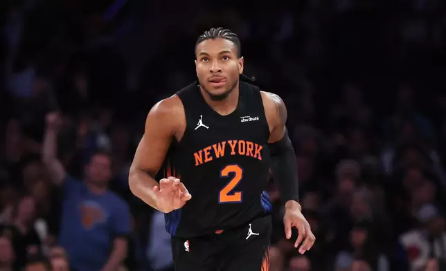 New York Knicks guard Miles McBride reacts after scoring a 3-point basket during the first half of an NBA basketball game against the Utah Jazz, Friday, Dec. 5, 2025, in New York. (AP Photo/Heather Khalifa)