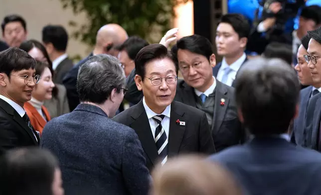 South Korean President Lee Jae Myung, center, leaves after a news conference to mark the first anniversary of the Dec. 3 martial law crisis at the Blue House in Seoul, South Korea, Wednesday, Dec. 3, 2025. (AP Photo/Ahn Young-joon)