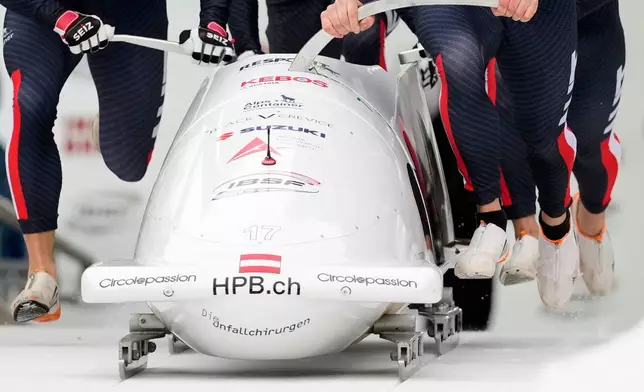 Markus Treichl, Markus Sammer, Sascha Stepan and Kristian Huber, of Austria, compete in the 4-man bobsleigh race at the Bobsleigh World Cup in Innsbruck, Austria, Sunday, Nov. 30, 2025. (AP Photo/Matthias Schrader)