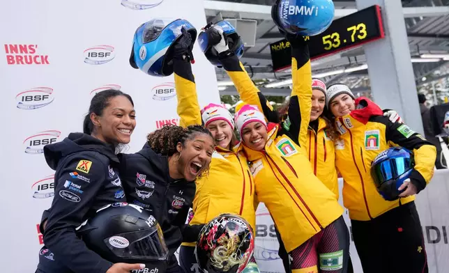Second placed Kaysha Love and Sylvia Hoffman, of the United States, winners Laura Nolte and Deborah Levi, of Germany, and third placed Kim Kalicki and Leonie Fiebig, of Germany, from left, pose together after the 2-woman bobsleigh race at the Bobsleigh World Cup in Innsbruck, Austria, Sunday, Nov. 30, 2025. (AP Photo/Matthias Schrader)