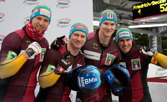Francesco Friedrich, Tim Becker, Alexander Schueller and Felix Straub, of Germany, pose after winning the 4-man bobsleigh race at the Bobsleigh World Cup in Innsbruck, Austria, Sunday, Nov. 30, 2025. (AP Photo/Matthias Schrader)