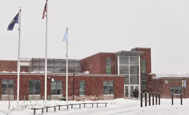 A Somali flag flies alongside the United States and Vermont flags outside the Winooski School District building, Wednesday, Dec. 10, 2025, in Winooski, Vt. (AP Photo/Amanda Swinhart)