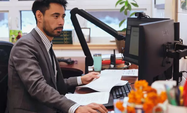 Winooski School District Superintendent Wilmer Chavarria works at his desk, Wednesday, Dec. 10, 2025, in Winooski, Vt. (AP Photo/Amanda Swinhart)
