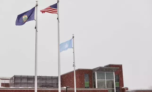 A Somali flag flies alongside the United States and Vermont flags outside the Winooski School District building, Wednesday, Dec. 10, 2025, in Winooski, Vt. (AP Photo/Amanda Swinhart)