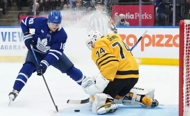 Toronto Maple Leafs forward Steven Lorentz (18) scores past Pittsburgh Penguins goaltender Stuart Skinner (74) during the second period of an NHL hockey game in Toronto, Tuesday, Dec. 23, 2025. (Nathan Denette/The Canadian Press via AP)