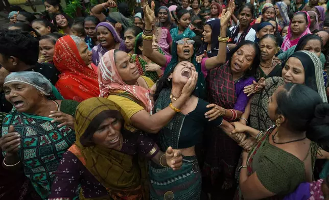 Family members and relatives of Akash Patni, a victim of the Air India plane crash, grieves during his funeral procession in Ahmedabad, India, Tuesday, June 17, 2025. (AP Photo/Ajit Solanki, File)