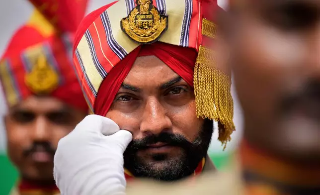 A Sikh paramilitary soldier adjusts his moustache before taking part in a parade during the country's Independence Day celebrations in Guwahati, India, Friday, Aug. 15, 2025. (AP Photo/Anupam Nath, File)