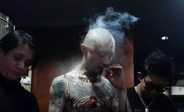 A Chinese punk rocker smokes a cigarette as he waits backstage during a punk festival in Hangzhou, China, Friday, Jan. 17, 2025. (AP Photo/Aaron Favila, File)