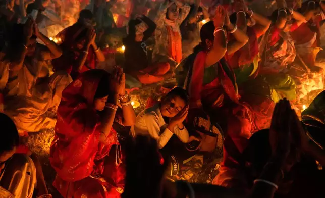 Devotees pray with lamps during a ritual of Rakher Upobash, a Hindu religious festival that involves a daylong fast and overnight prayer seeking spiritual purification, honoring Hindu saint Loknath Brahmachari, at a temple in Chakla, West Bengal, India, Saturday, Nov. 15, 2025. (AP Photo/Bikas Das, File)