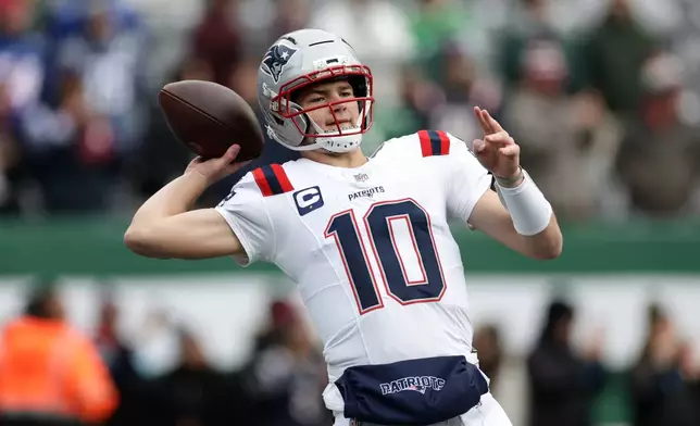 New England Patriots quarterback Drake Maye warms up before an NFL football game against the New York Jets, Sunday, Dec. 28, 2025, in East Rutherford, N.J. (AP Photo/Adam Hunger)