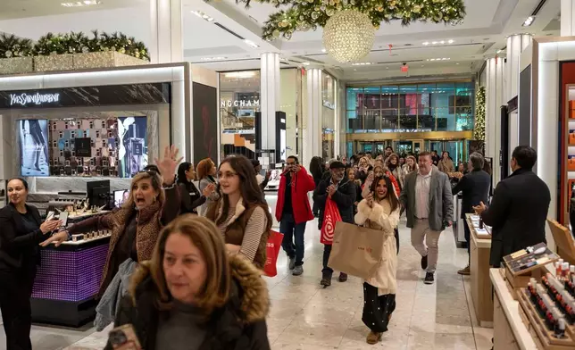 Customers walk into Macy's flagship store, Friday, Nov. 21, 2025, in New York. (AP Photo/Yuki Iwamura)