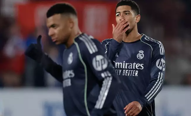 Real Madrid's Jude Bellingham, right, reacts next to his teammate Real Madrid's Kylian Mbappe during the Copa del Rey soccer match between Talavera and Real Madrid, in Talavera de la Reina, Spain, Wednesday, Dec. 17, 2025. (AP Photo/M. Berengui)