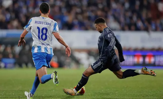 Real Madrid's Kylian Mbappe, right, vies for the ball with Talavera's Carreras during the Copa del Rey soccer match between Talavera and Real Madrid, in Talavera de la Reina, Spain, Wednesday, Dec. 17, 2025. (AP Photo/M. Berengui)