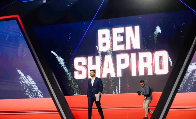 Ben Shapiro walks on stage before speaking during Turning Point USA's AmericaFest 2025, Thursday, Dec. 18, 2025, in Phoenix. (AP Photo/Jon Cherry)