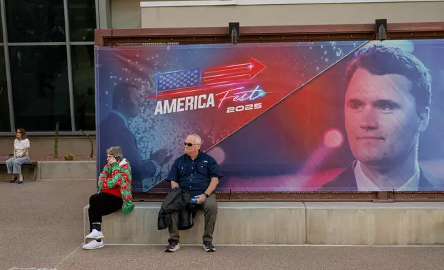 Attendees sit and rest during Turning Point USA's AmericaFest 2025, Thursday, Dec. 18, 2025, in Phoenix. (AP Photo/Jon Cherry)