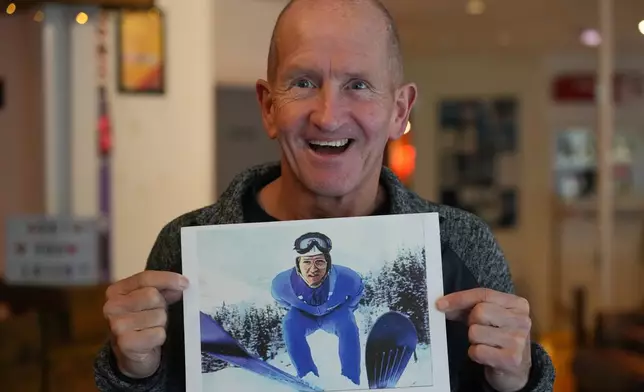 British former ski jumper Michael Edwards, known as Eddie the Eagle, displays one of his first ever taken press photos during an interview at the Ski and Snowboard Center, in Gloucester, England, Wednesday, Nov. 19, 2025. (AP Photo/Frank Augstein)