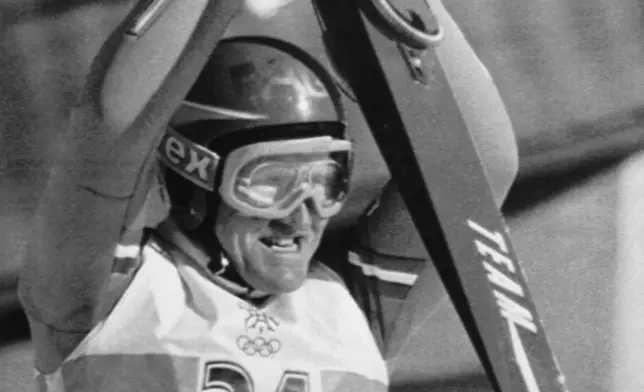 FILE - British ski jumper Michael Edwards known as Eddie The Eagle celebrates a jump, during the Winter Olympics 90 meter ski jumping competition at Calgary's Olympic Park, on Feb. 23, 1988. (AP Photo/Jack Smith, File)