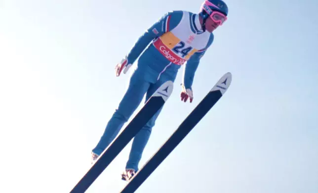 FILE - British ski jumper Michael Edwards known as Eddie The Eagle flies towards 58th, and last place, in the 70 meter ski jump at the Winter Olympics, in Calgary, February 14, 1988. (AP Photo/Katsumi Kasahara, File)
