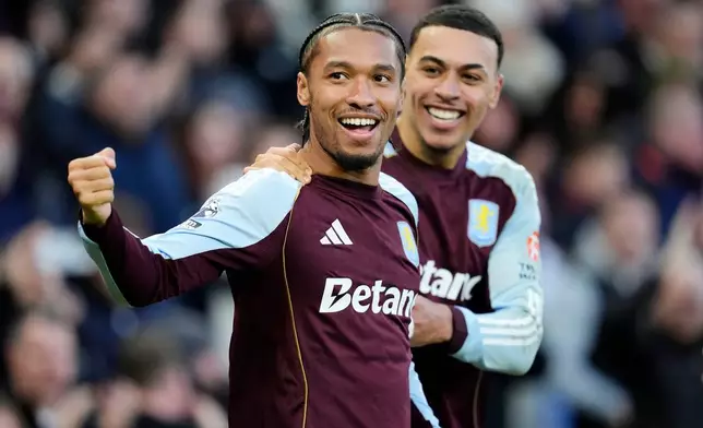 Aston Villa's Boubacar Kamara, foreground, celebrates with Aston Villa's Morgan Rogers after scoring his side's first goal, during the English Premier League soccer match between Aston Villa and Wolverhampton Wanderers, at Villa Park, in Birmingham, England, Sunday, Nov. 30, 2025. (Nick Potts/PA via AP)