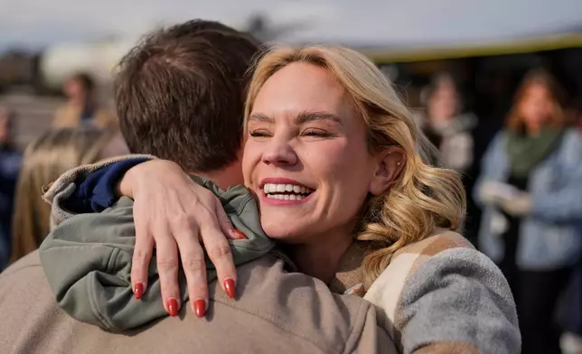Democratic congressional candidate and state Rep. Aftyn Behn, D-Nashville, hugs a supporter during a campaign event in the special election for the seventh district Saturday, Nov. 29, 2025, in Nashville, Tenn. (AP Photo/George Walker IV)