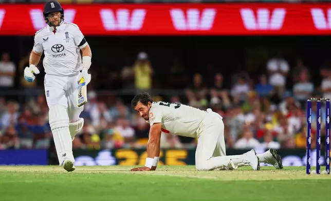 England's Joe Root runs between the wickets as Australia's Mitchell Starc fields on the ground during the second Ashes cricket test match between Australia and England in Brisbane, Thursday, Dec. 4, 2025.. (AP Photo/Tertius Pickard)
